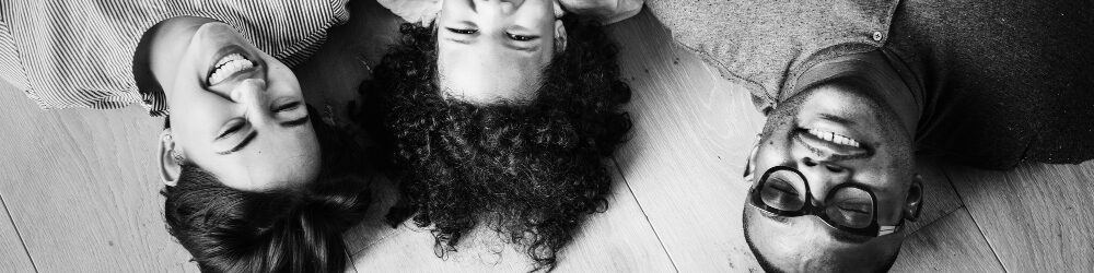 black-family-lying-wooden-floor-design-space