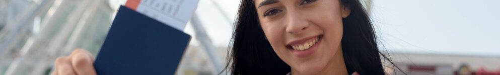 portrait-smiling-woman-showing-air-ticket-passport