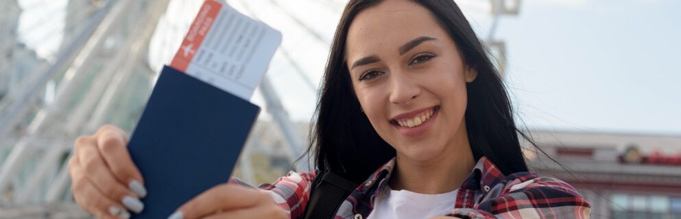 portrait-smiling-woman-showing-air-ticket-passport